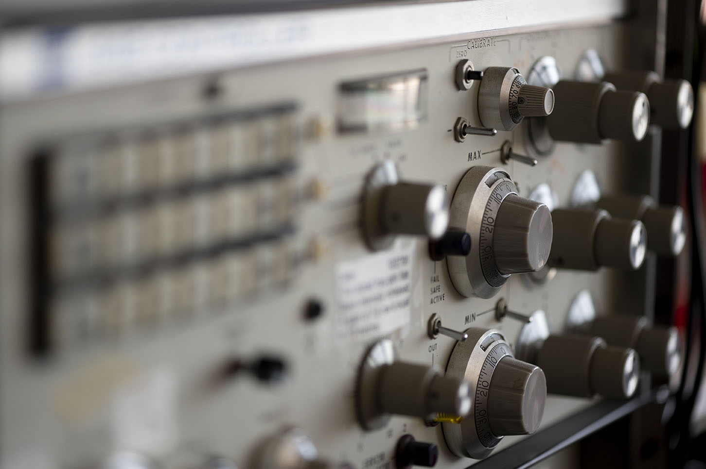 A picture of some equipment with many knobs and switches