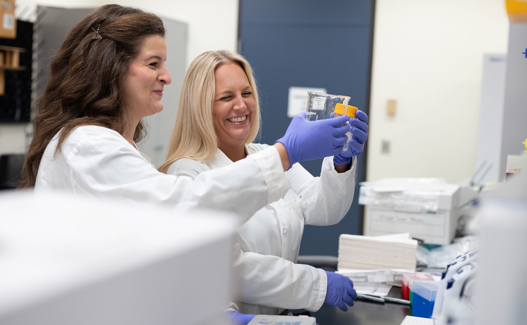 Two scientists discuss a specimen in the lab