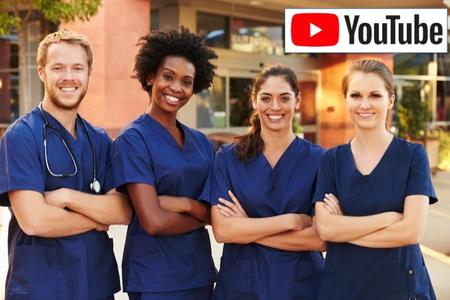 four dentists in navy scrubs with folded arms smiling at the camera