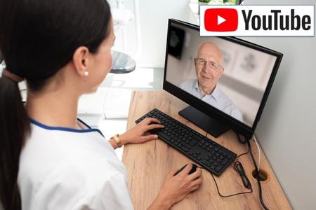 woman in scrubs talks with senior patient on computer screen