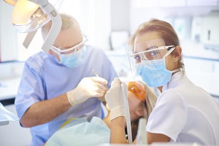 Dentist and hygenist working on patient