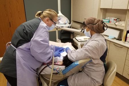 School of Dentistry students take care of a patient at Walker Center