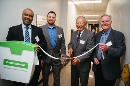 Keith Mays, Robert Nadeau, Harold Tu and Bruce Templeton at a ribbon cutting for the OMS Clinic