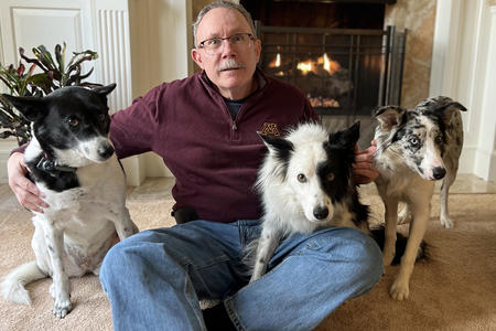 Photo of Scott McClanahan surrounded by three dogs