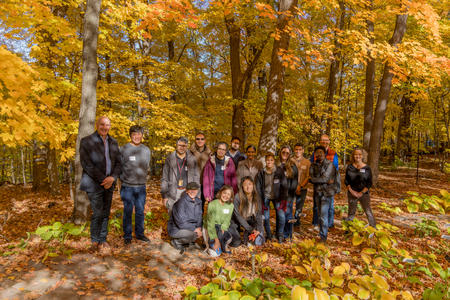 Group of Fall Research Retreat attendees in a forest of autumn leaves