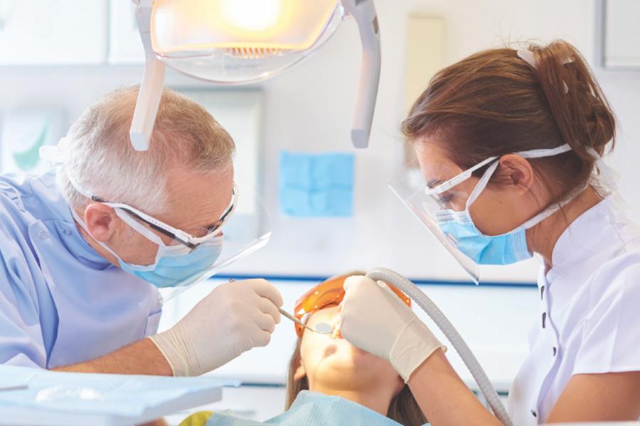 Dentist and hygenist working on patient