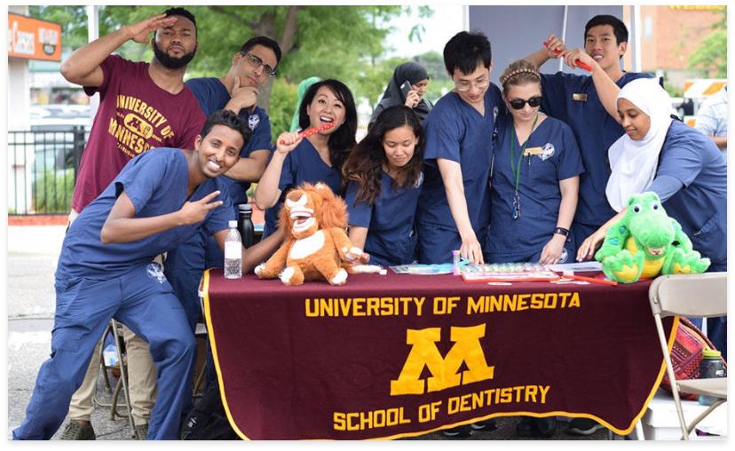 School of Dentistry students posing at outdoor information booth