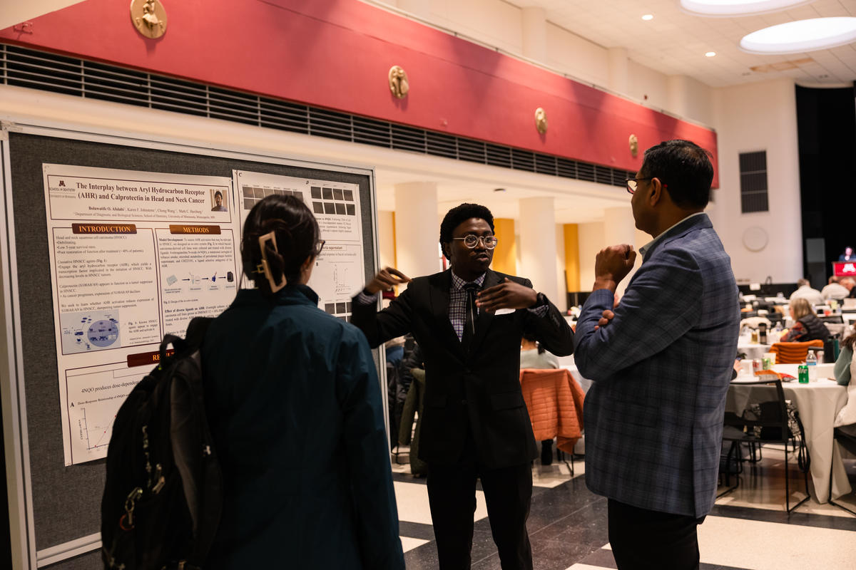 Researchers share their posters with attendees