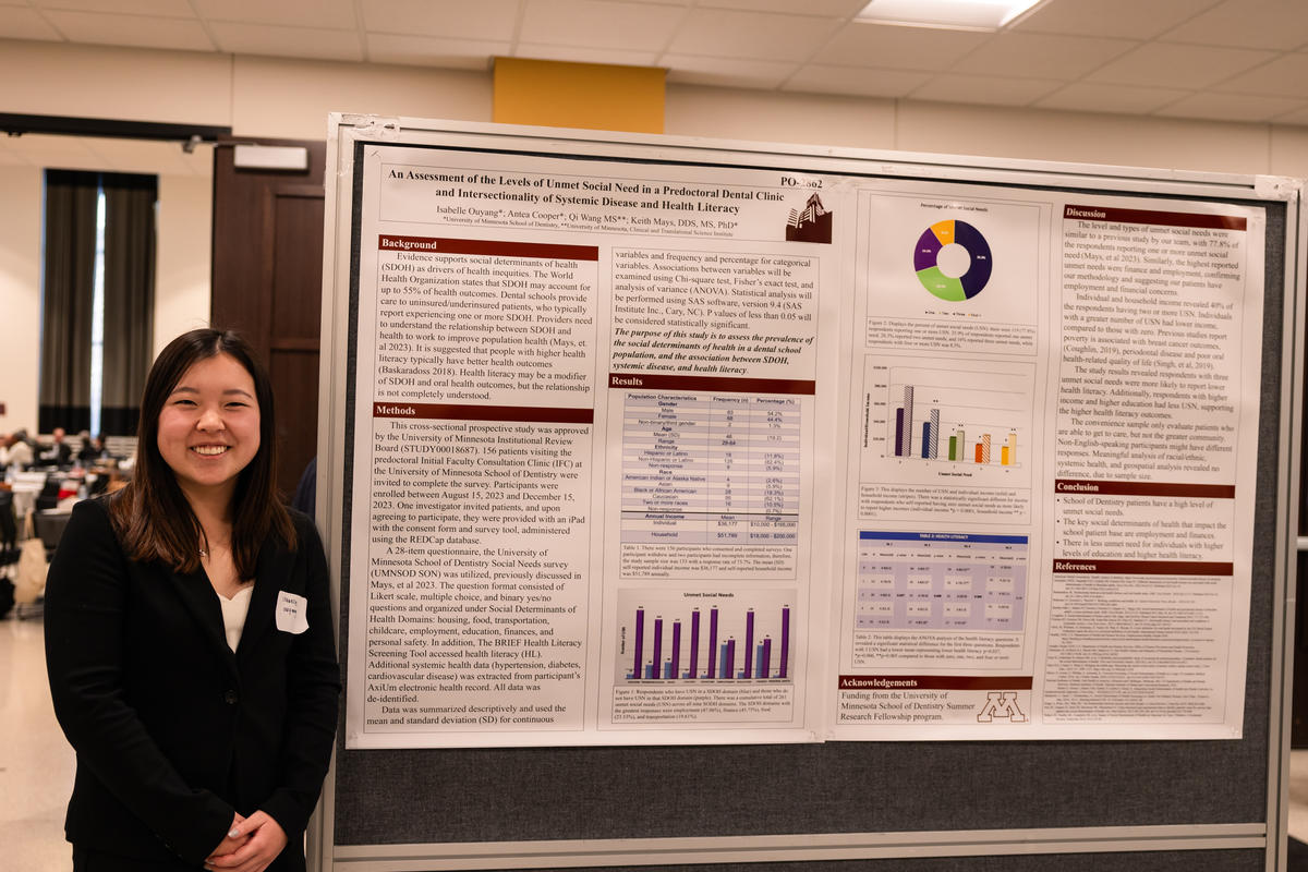 Researcher poses in front of her poster