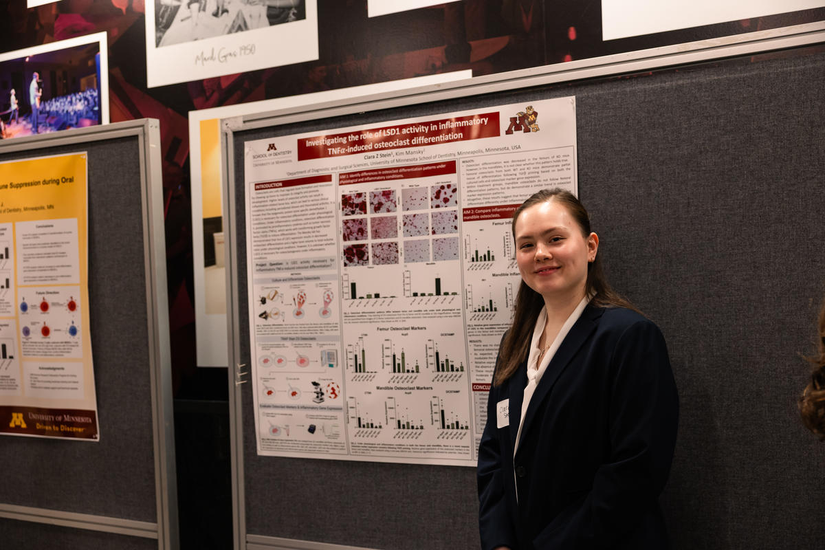 A researcher poses with her poster