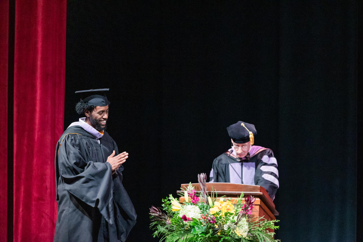 Michael Abebe smiles as he crosses the stage