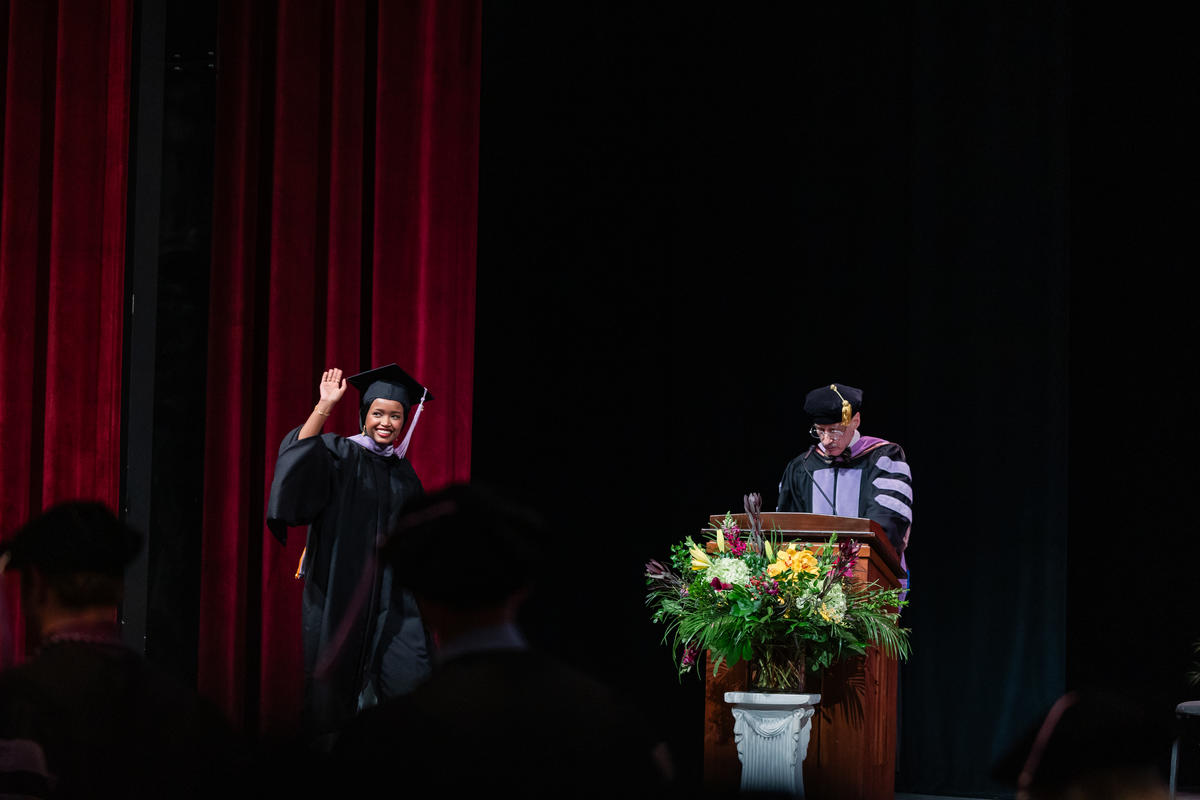 Mulki Hassan waves as she crosses the stage