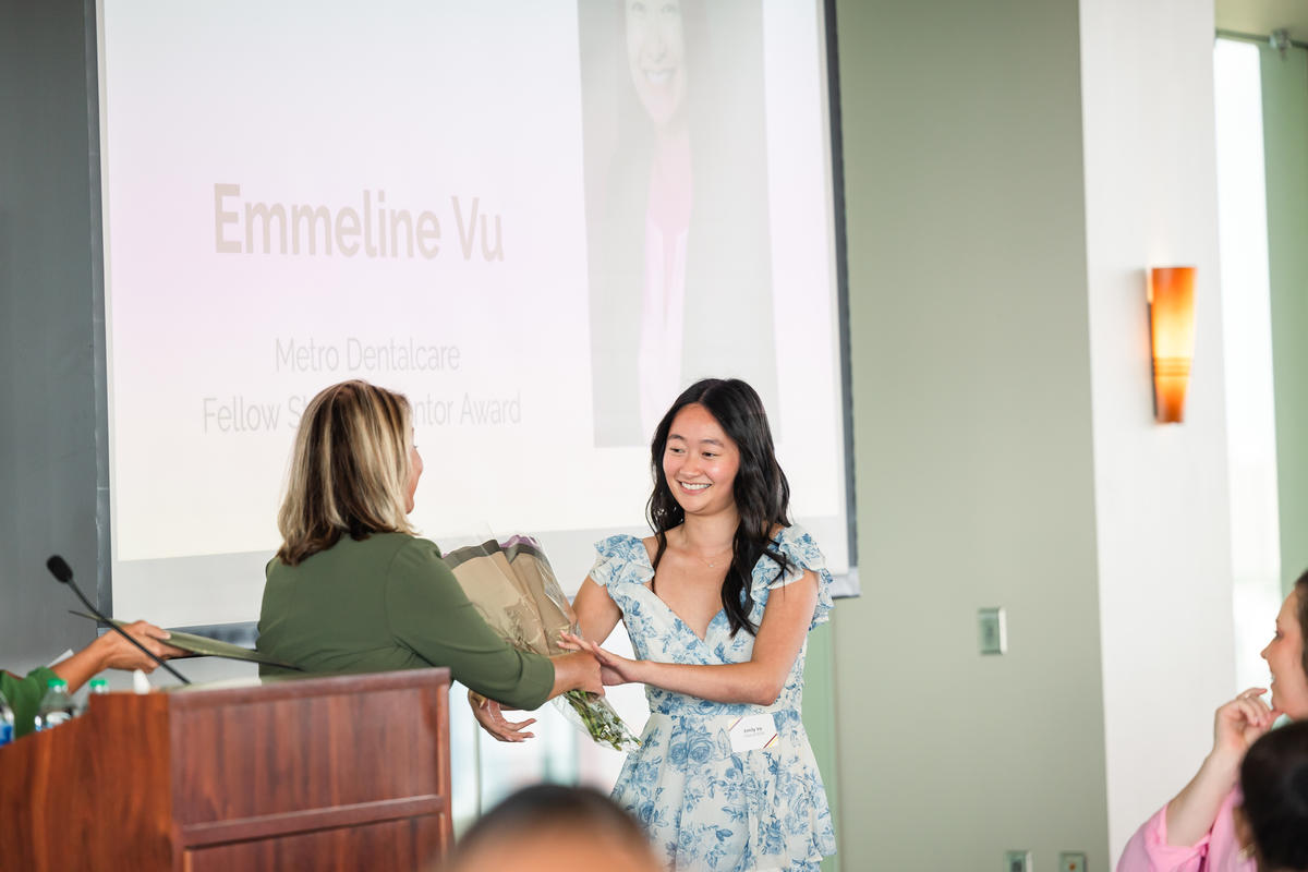 Emmeline Vu receives flowers as part of her award 
