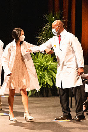 Dean Keith Mays congratulates a student at the 2021 White Coat Ceremony