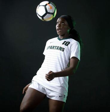Kristelle Yewah in a styled shoot with a soccer ball