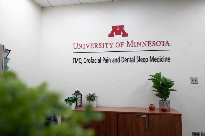 Sign and front desk of the University of Minnesota's TMD, Orofacial Pain and Dental Sleep Medicine Clinic