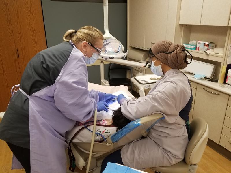 School of Dentistry students take care of a patient at Walker Center
