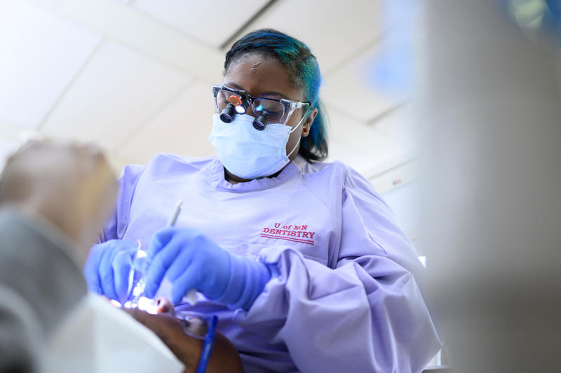 a dental therapy student practices in clinic on a patient