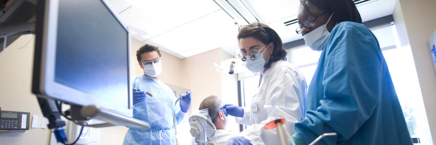 students with advanced education program operate on a patient