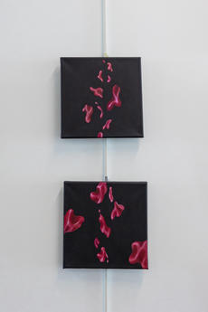 Two black canvases feature red droplets reminiscent of blood cells 