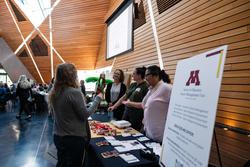 Members of the office of research and discovery present materials at the table fair