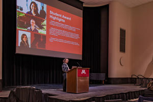 Kristin Bruk Artinger speaks from a podium at Research Day
