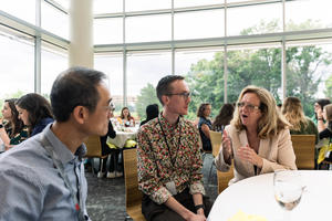 Three researchers talk at lunch