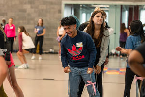 Students participate in a tandem ski walking activity
